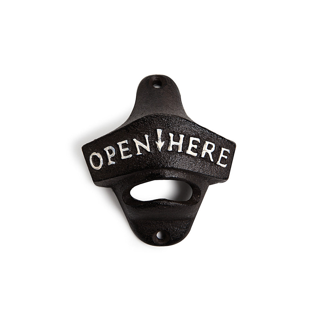 Cast iron bottle opener that says Open Here in white text.